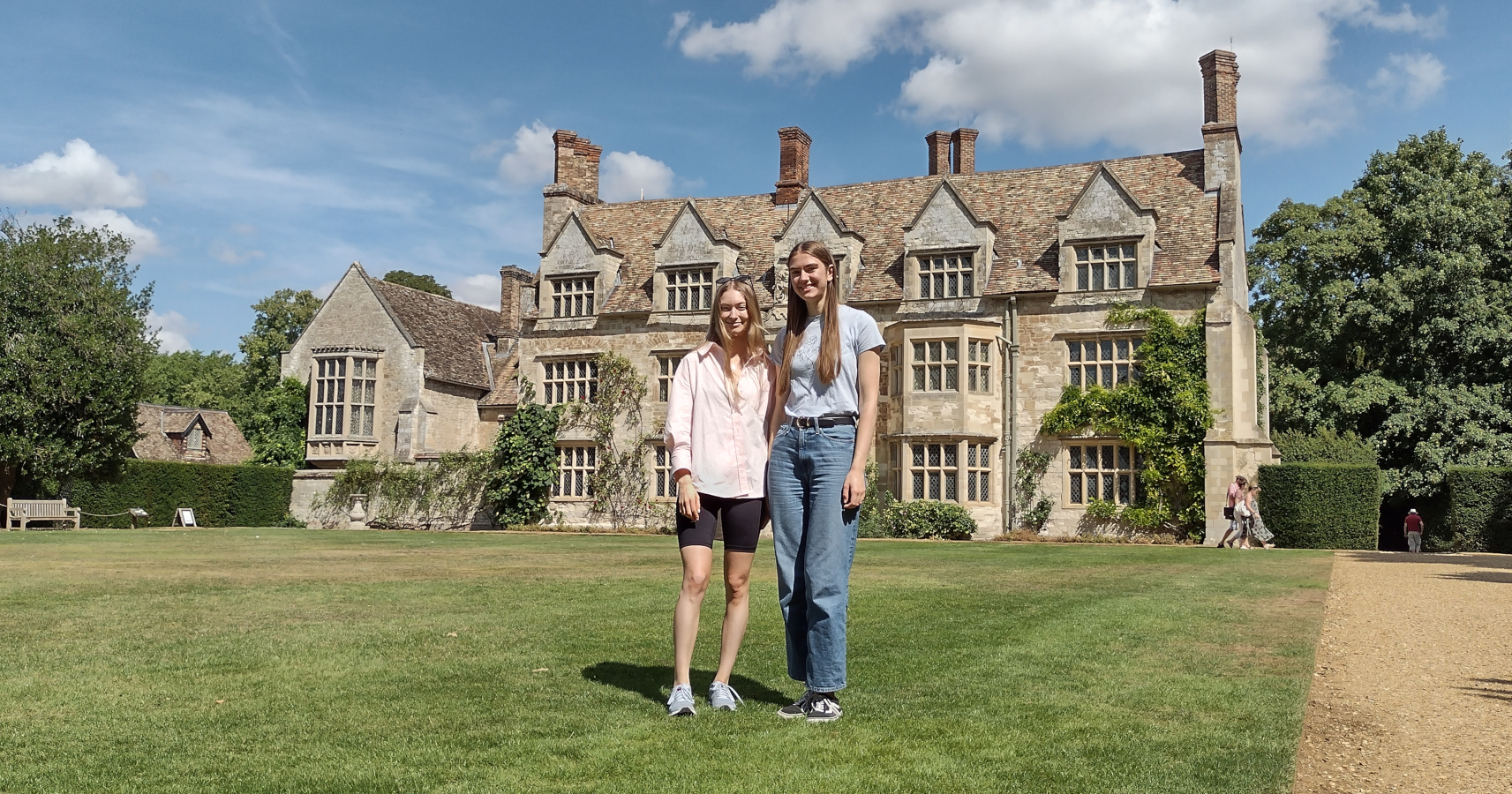 Ilona Basset and Emma Beniston standing in front of Anglesey Abbey, a stately home