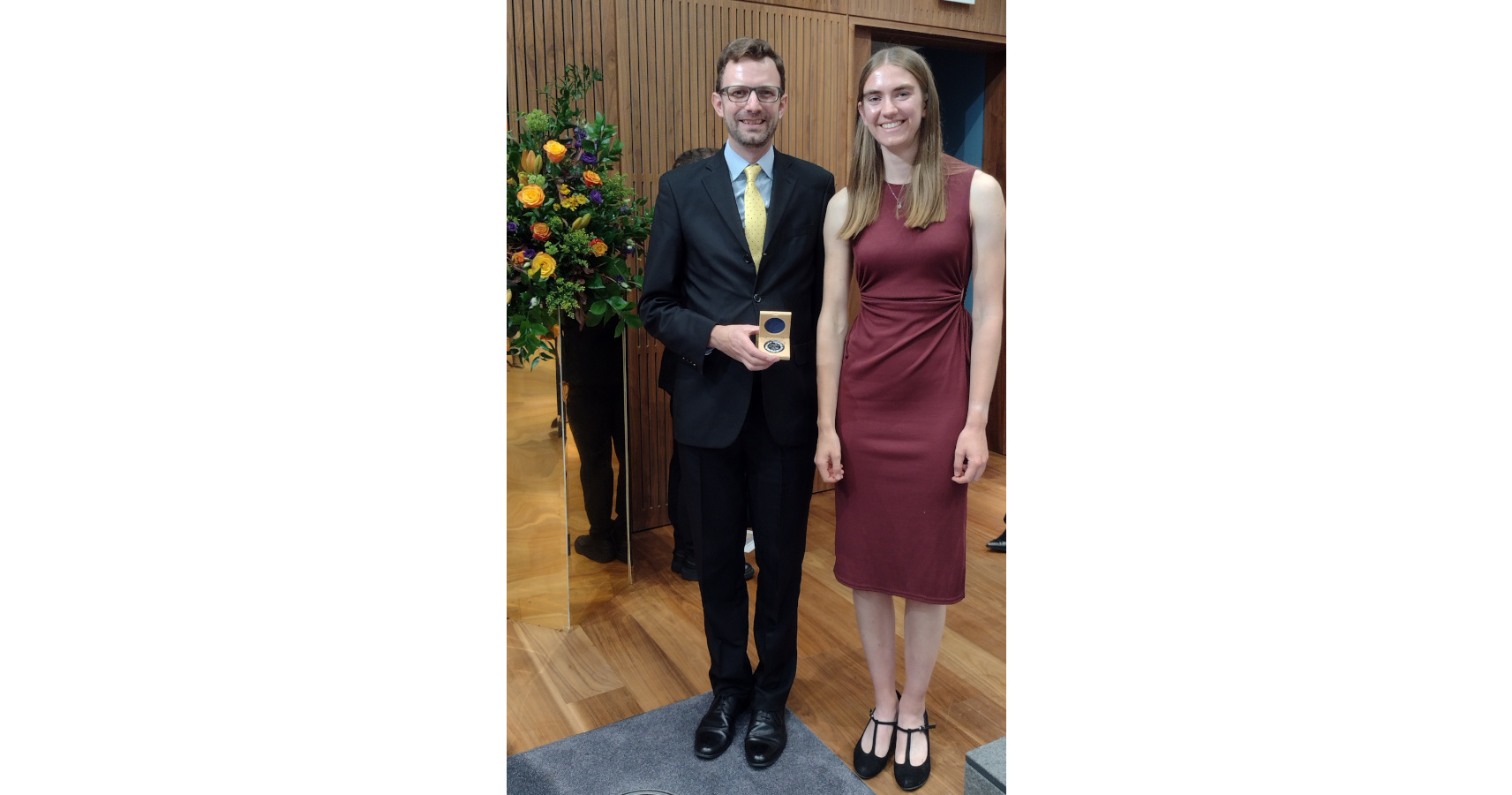 Jordan Skittrall and Emma Beniston in formal wear at the Royal College of Pathologists, Jordan holding a research medal