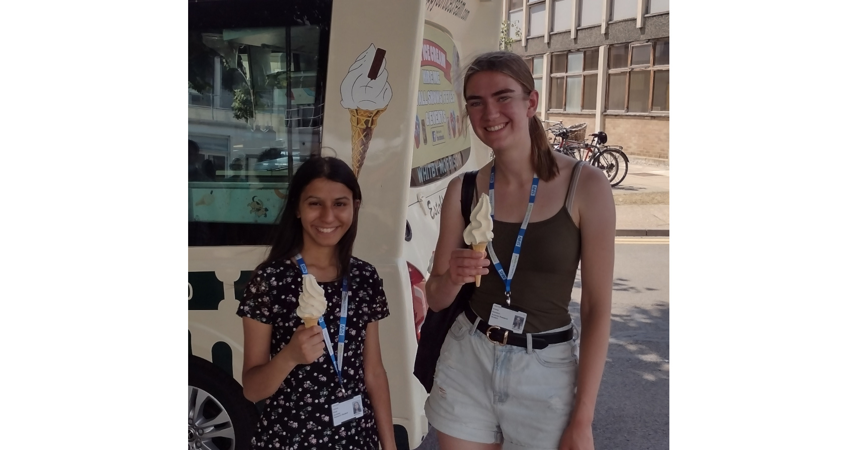 Vianca Shah and Emma Beniston with ice creams by an ice cream van